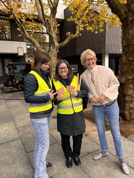 Vlnr: Franziska Knake (Fachbereichsleitung Straßenreinigung / Stabsstelle Stadtsauberkeit), Franziska Neßmann (Wirtschaftsförderung), Andrea Quilling (Fachbereichsleitung Wirtschaftsförderung) verteilen kostenlose Taschenaschenbecher